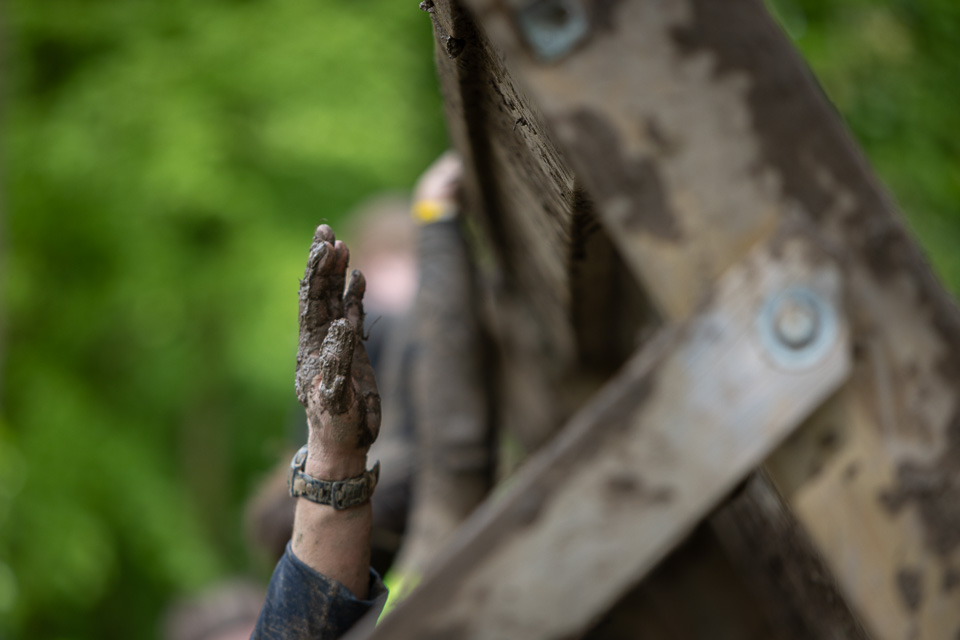 Reaching in the mud run