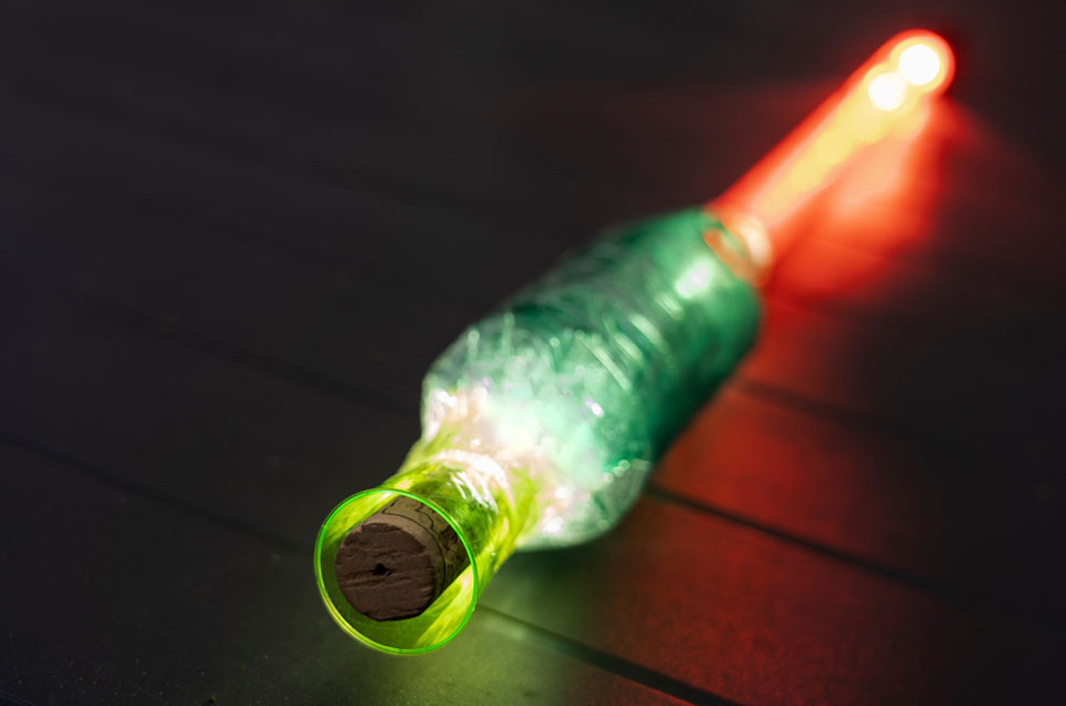 Red tube with green bottle and cork
